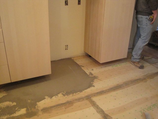 The solution:  floor cement filler, troweled smooth, but not necessarily level.