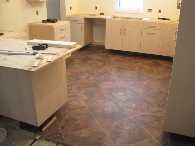 The end result, a smooth, albeit not level, beautiful and functional floor to complement the cabinet and kitchen colors.